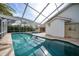 Serene pool and spa with a covered patio and lush landscaping at 26266 Barcelos Ct, Punta Gorda, FL 33983