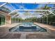 Relaxing screened pool and spa with tiled deck at 26266 Barcelos Ct, Punta Gorda, FL 33983