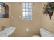 Small half bathroom with pedestal sink and toilet at 26266 Barcelos Ct, Punta Gorda, FL 33983