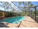 Inviting kidney-shaped pool with screened enclosure at 272 Cedar St, Englewood, FL 34223