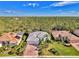 Single-Gathering home with tile roof and paver driveway, nestled in a wooded area at 2864 Mill Creek Rd, Port Charlotte, FL 33953