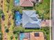 Aerial view of a home with a pool and well-maintained landscaping at 2864 Mill Creek Rd, Port Charlotte, FL 33953