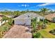 Attractive single-story home with tile roof, paver driveway, and lush landscaping at 2864 Mill Creek Rd, Port Charlotte, FL 33953