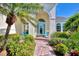 Welcoming front entry with light-colored walls, arched entryway, and teal chairs at 2864 Mill Creek Rd, Port Charlotte, FL 33953