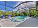 Inviting kidney-shaped pool with a spa and screened enclosure at 2864 Mill Creek Rd, Port Charlotte, FL 33953