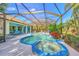 Relax in the luxurious screened pool and spa with outdoor kitchen at 2864 Mill Creek Rd, Port Charlotte, FL 33953