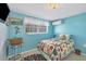 Small bedroom with a full-size bed and blue walls at 2871 13Th St, Englewood, FL 34224