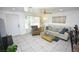 Living room featuring a beige sofa, armchair, and tiled floor at 4064 Harbor Blvd, Port Charlotte, FL 33952