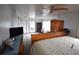 The main bedroom showcases warm wood furnishings, a ceiling fan, and plush carpet at 4064 Harbor Blvd, Port Charlotte, FL 33952