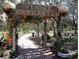 Entrance to Venice Arboretum features a wooden arch with flowering vines at 421 Riviera St, Venice, FL 34285