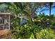 Landscaped backyard with tropical plants and screened porch at 421 Riviera St, Venice, FL 34285