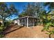 Screened porch and lush, landscaped backyard with mature trees at 421 Riviera St, Venice, FL 34285