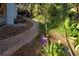 Brick pathway winds through a tropical garden alongside the home at 421 Riviera St, Venice, FL 34285