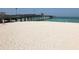 Sandy beach with pier and ocean in background at 421 Riviera St, Venice, FL 34285