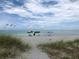 Relaxing beach scene with colorful umbrellas and a boat at 421 Riviera St, Venice, FL 34285