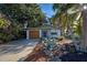 Front view of a renovated mid-century home with a spacious driveway at 421 Riviera St, Venice, FL 34285