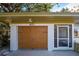 Attached two-car garage with a wood-like finish at 421 Riviera St, Venice, FL 34285