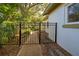 Black metal gate opens to a garden path at 421 Riviera St, Venice, FL 34285