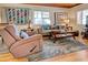 Living room with recliner, sofa, and wood-paneled ceiling at 421 Riviera St, Venice, FL 34285