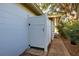 Private outdoor shower with white enclosure and brick pathway at 421 Riviera St, Venice, FL 34285