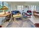 Relaxing sunroom boasts a cozy sitting area with unique vintage furniture at 421 Riviera St, Venice, FL 34285