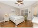 Bedroom features hardwood floors and a ceiling fan at 4370 Turnberry Cir, North Port, FL 34288