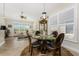 Bright dining area with glass table and view into living room at 4370 Turnberry Cir, North Port, FL 34288