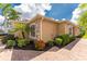 Side view of a tan house with stone accents and landscaping at 4370 Turnberry Cir, North Port, FL 34288