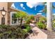 Landscaped walkway leading to a tan house with stone accents at 4370 Turnberry Cir, North Port, FL 34288