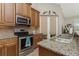 Stainless steel appliances and granite countertops highlight this kitchen at 4370 Turnberry Cir, North Port, FL 34288