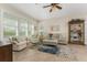 Living room with beige sofa, armchairs, and a large window at 4370 Turnberry Cir, North Port, FL 34288