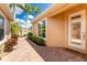 Brick walkway leading to a white door with glass panels; welcome mat at 4370 Turnberry Cir, North Port, FL 34288