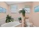 Spa-like bathroom with a jetted tub and plenty of plants at 4557 Colleen St, Port Charlotte, FL 33952