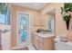 Bathroom with dual sinks, a toilet, and access to the pool at 4557 Colleen St, Port Charlotte, FL 33952