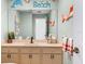 Beach-themed bathroom with a single sink and vanity at 4557 Colleen St, Port Charlotte, FL 33952