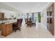 Bright dining room with built-in desk and glass-top table at 4557 Colleen St, Port Charlotte, FL 33952