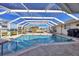 Inviting screened pool area with patio furniture, offering ample space for relaxation and entertainment at 4557 Colleen St, Port Charlotte, FL 33952