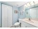 Simple bathroom with white vanity, toilet, and beach-themed decor at 50 Meredith Dr # 12, Englewood, FL 34223