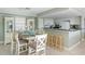 Bright dining area with a rustic table and white chairs at 50 Meredith Dr # 12, Englewood, FL 34223