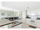 Open concept kitchen boasts granite countertops and white cabinetry at 50 Meredith Dr # 12, Englewood, FL 34223