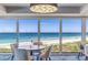 Stunning ocean view from a dining area with large windows and seating for four at 5000 Gasparilla Rd # 48, Boca Grande, FL 33921