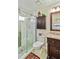 Bathroom with a walk-in shower, granite vanity, and a toilet at 601 Bramblewood Ln, Englewood, FL 34223