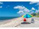 Relaxing beach scene with chairs and umbrella at 601 Bramblewood Ln, Englewood, FL 34223