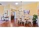 Dining area with hardwood floors, chandelier, and white table set at 601 Bramblewood Ln, Englewood, FL 34223