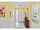 Bright and spacious entryway with hardwood floors and a view of a bedroom at 601 Bramblewood Ln, Englewood, FL 34223