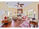 Living room with hardwood floors, fireplace, and large windows at 601 Bramblewood Ln, Englewood, FL 34223