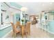 Bright breakfast nook with glass-top table and wicker chairs at 70 Marker Rd, Rotonda West, FL 33947