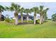 Landscaped backyard with palm trees at 70 Marker Rd, Rotonda West, FL 33947