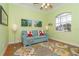 Bright living room featuring a light blue couch and a floral rug at 70 Marker Rd, Rotonda West, FL 33947