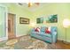 Bright living room featuring a light blue couch and a floral rug at 70 Marker Rd, Rotonda West, FL 33947